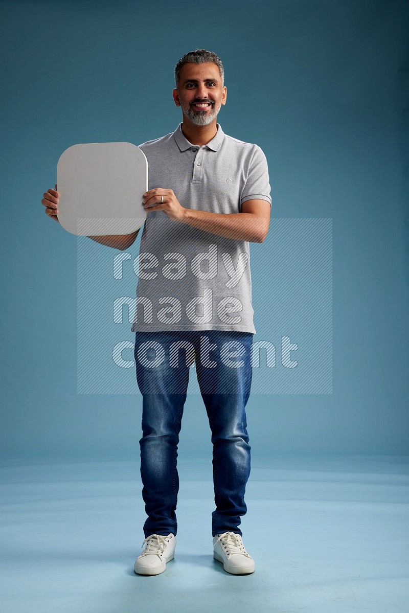 Man Standing holding social media sign on blue background