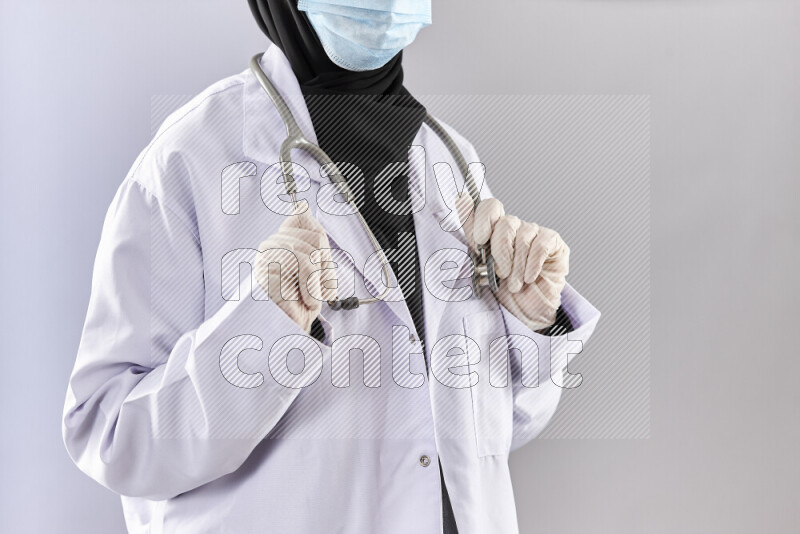Female doctor wearing an abaya and medical attire in different positions