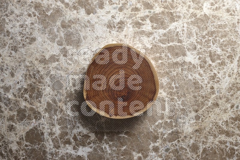 A wooden tray on beige marble background
