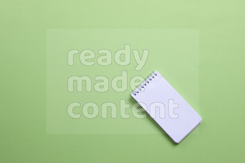 A blank open notebook on green background