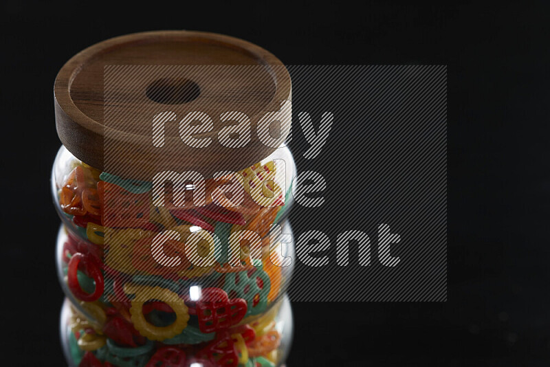 Snacks in a glass jar on black background