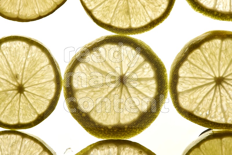 Lemon slices on illuminated white background