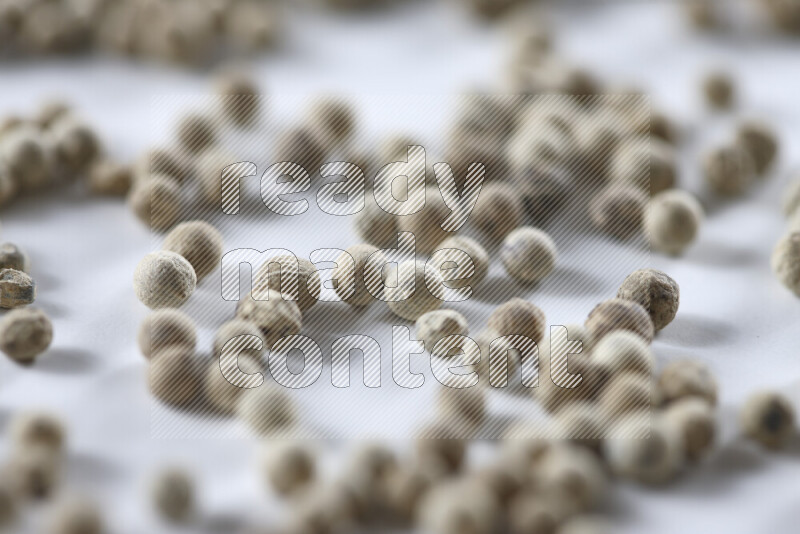 White pepper beads on white background