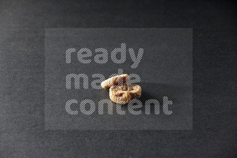 Two dried figs on a black background in different angles