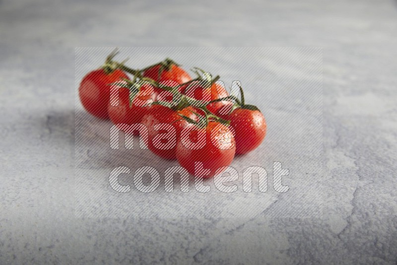 Red cherry tomato vein on a light grey textured background 45 degree