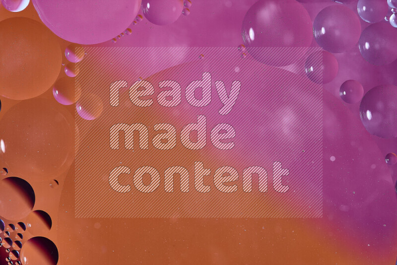 Close-ups of abstract oil bubbles on water surface in shades of orange and pink