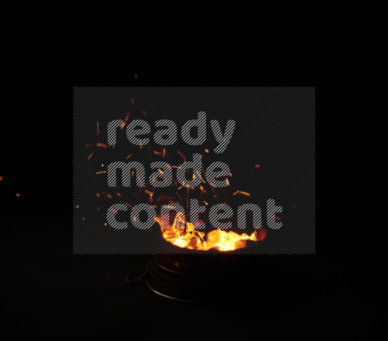 Coal cubes on fire in metal pan