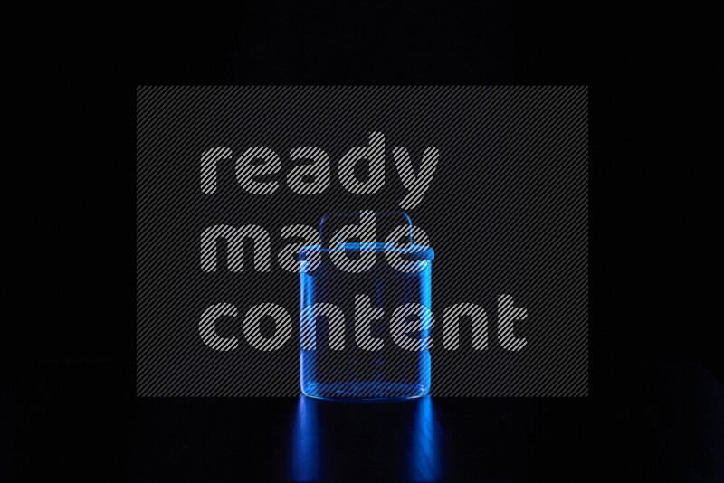 Glassware with rim light in blue against black background