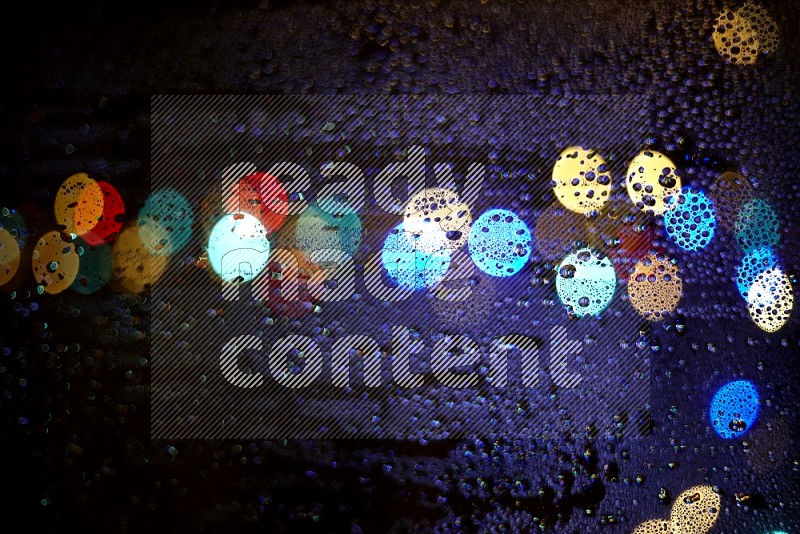 Bokeh light in multicolor with water drops