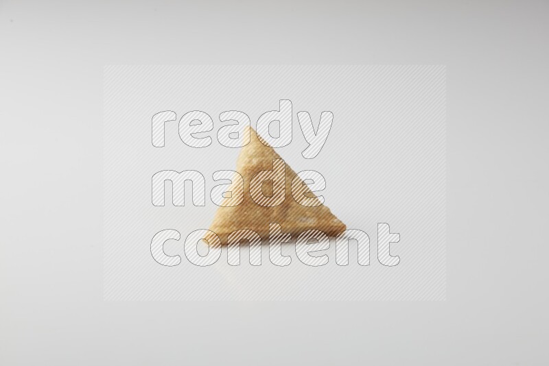 One fried sambosa on a white background
