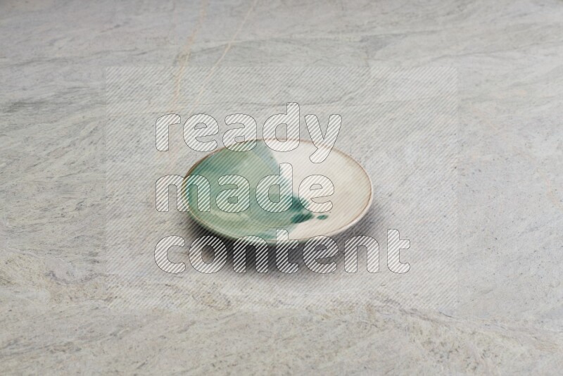 Multicolored Pottery Plate On Grey Marble Flooring