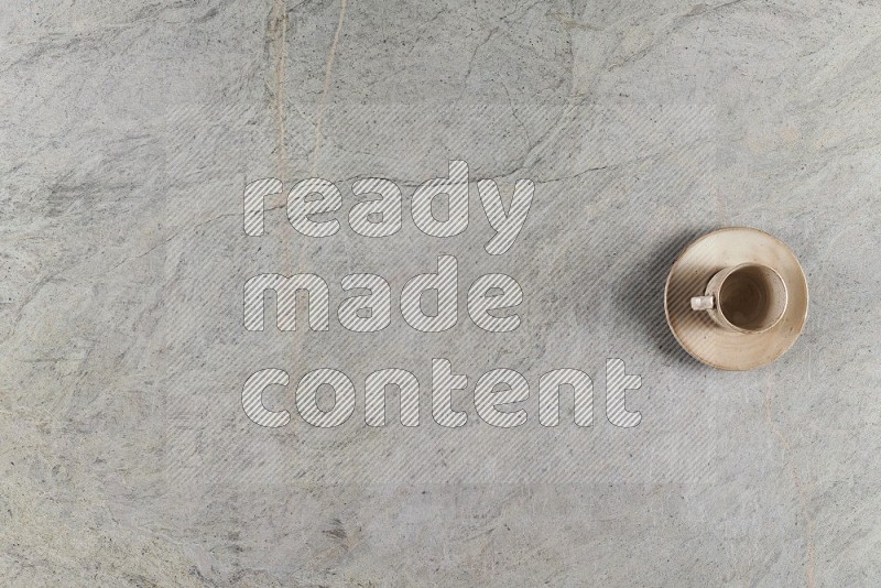 Top View Shot Of A Multicolored Pottery Cup On Grey Marble Flooring