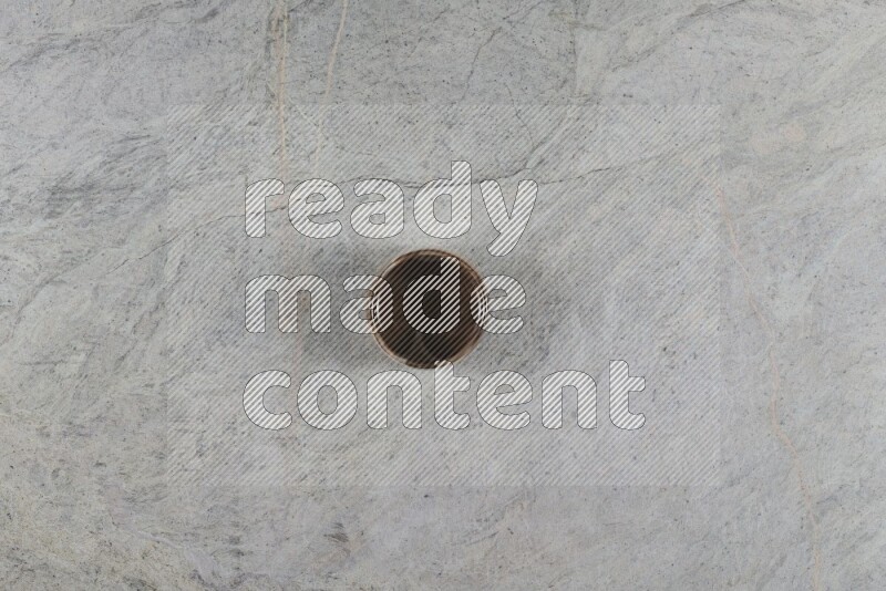 A multicolored pottery Cup on grey marble background