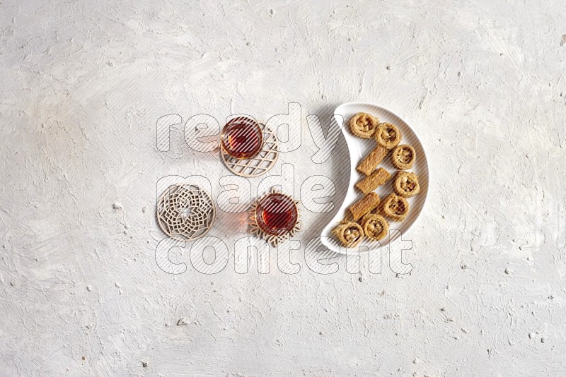Oriental sweets in a pottery plate with drinks in a light setup