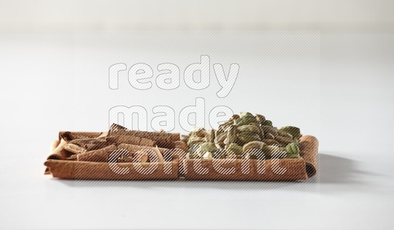 2 squares of cinnamon sticks full of cinnamon and cardamom on white flooring