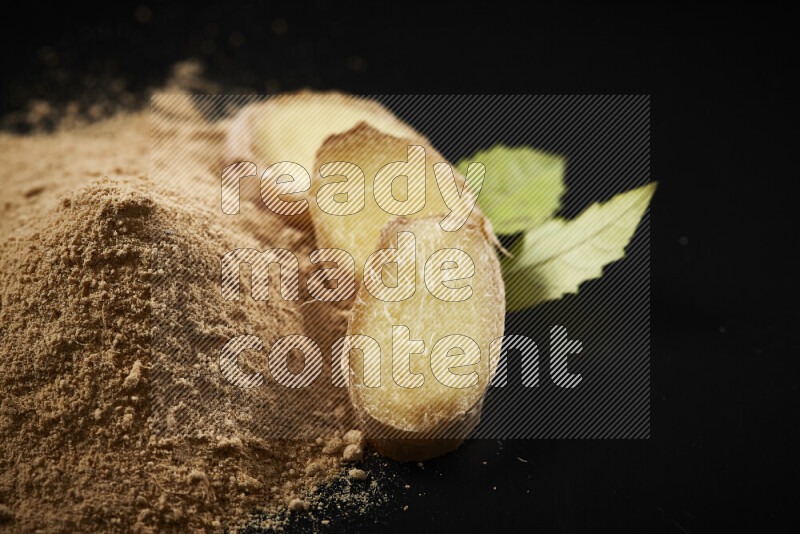 A bunch of ground ginger powder on black background