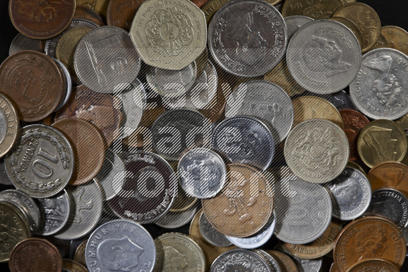 A close-ups of random old coins on black background