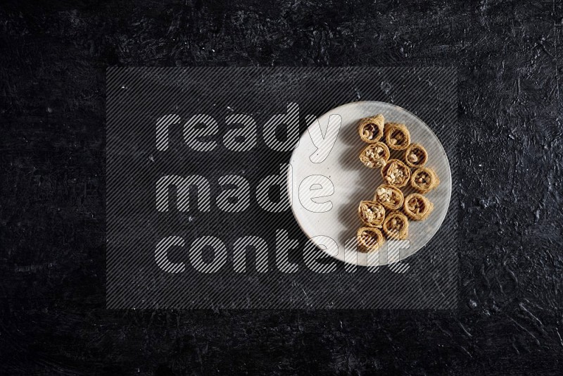 Konafa in a pottery plate in a dark setup