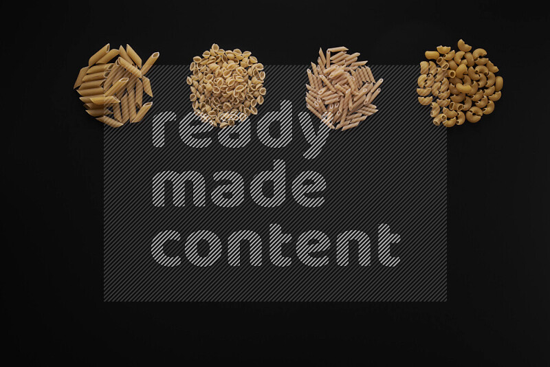 Different pasta types in 4 bunches on black background