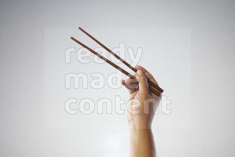 Male Hand Holding Chop Stick on white background
