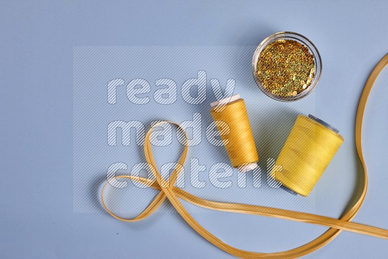 Yellow sewing supplies on blue background