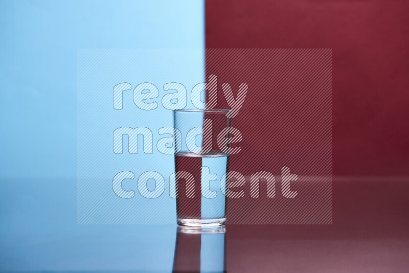 The image features a clear glassware filled with water, set against light blue and dark red background