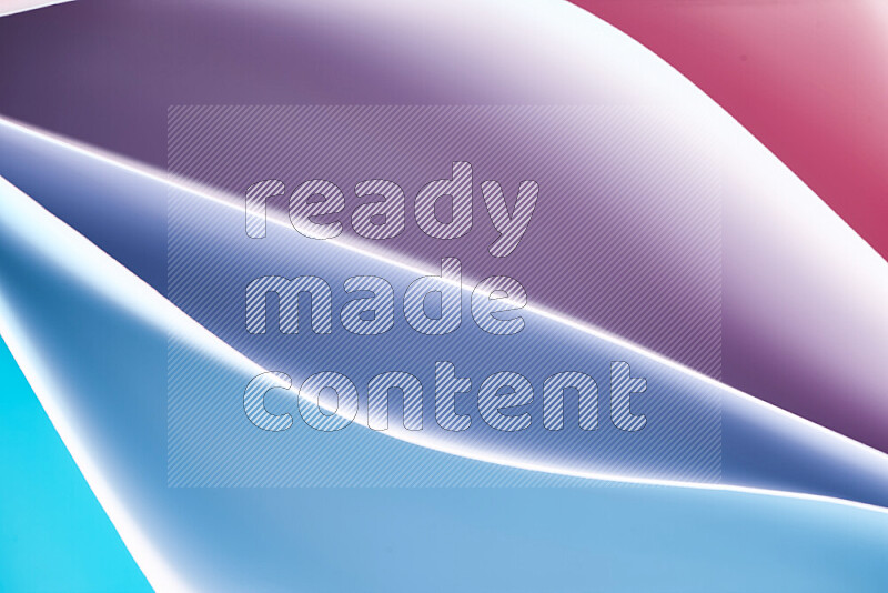 This image showcases an abstract paper art composition with paper curves in blue and red gradients created by colored light