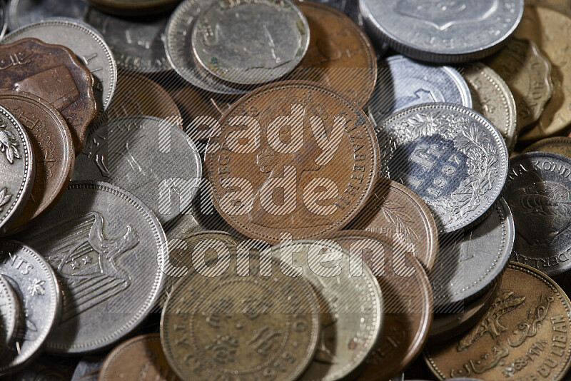 A close-ups of random old coins on black background