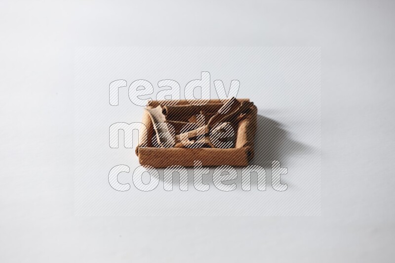 A single square of cinnamon sticks full of cinnamon on white flooring