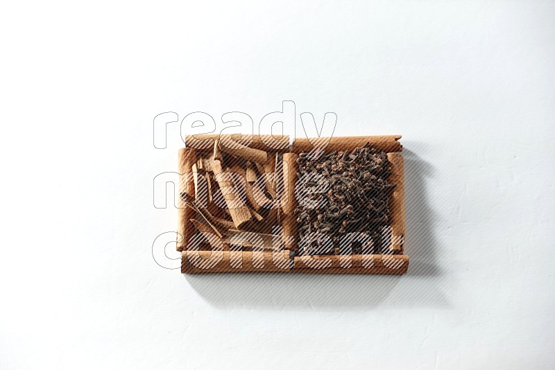 2 squares of cinnamon sticks full of cloves and cinnamon on white flooring