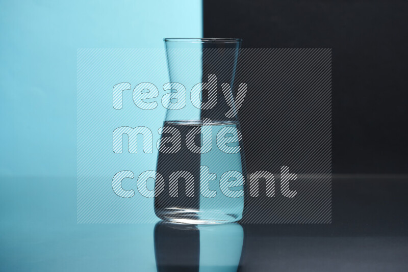 The image features a clear glassware filled with water, set against light blue and black background