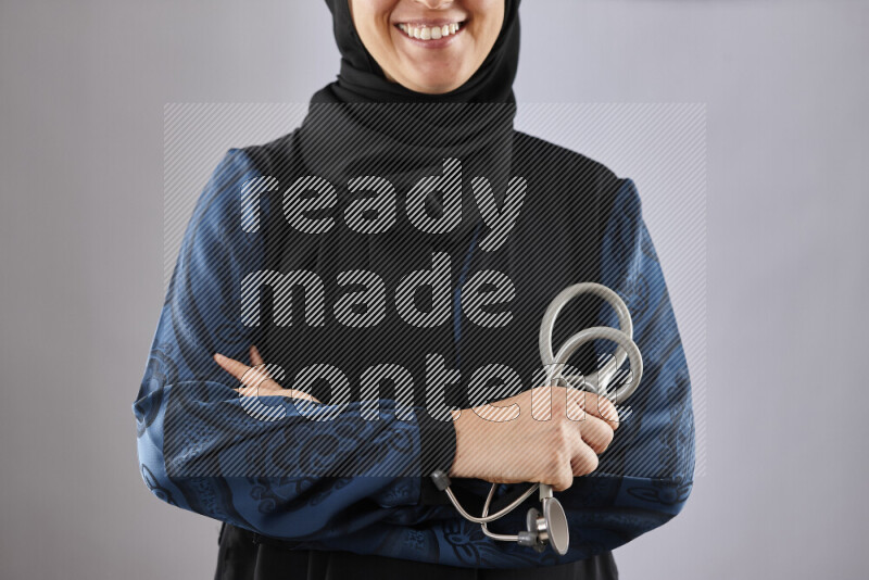 Female doctor wearing an abaya and medical attire in different positions