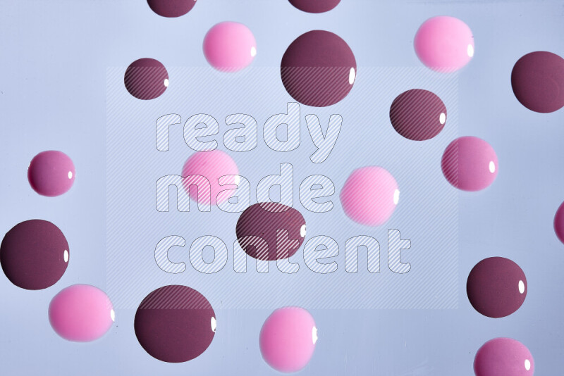 Close-ups of abstract purple and pink paint droplets on the surface