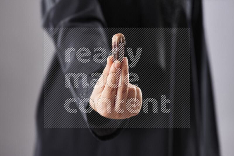 Woman in abaya holding dates in different positions