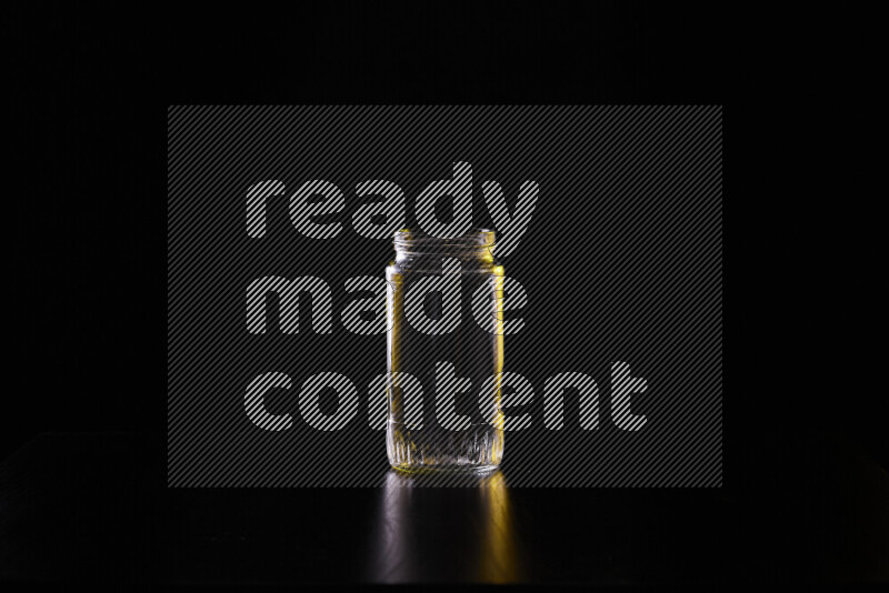 Glassware with rim light in yellow and white against black background