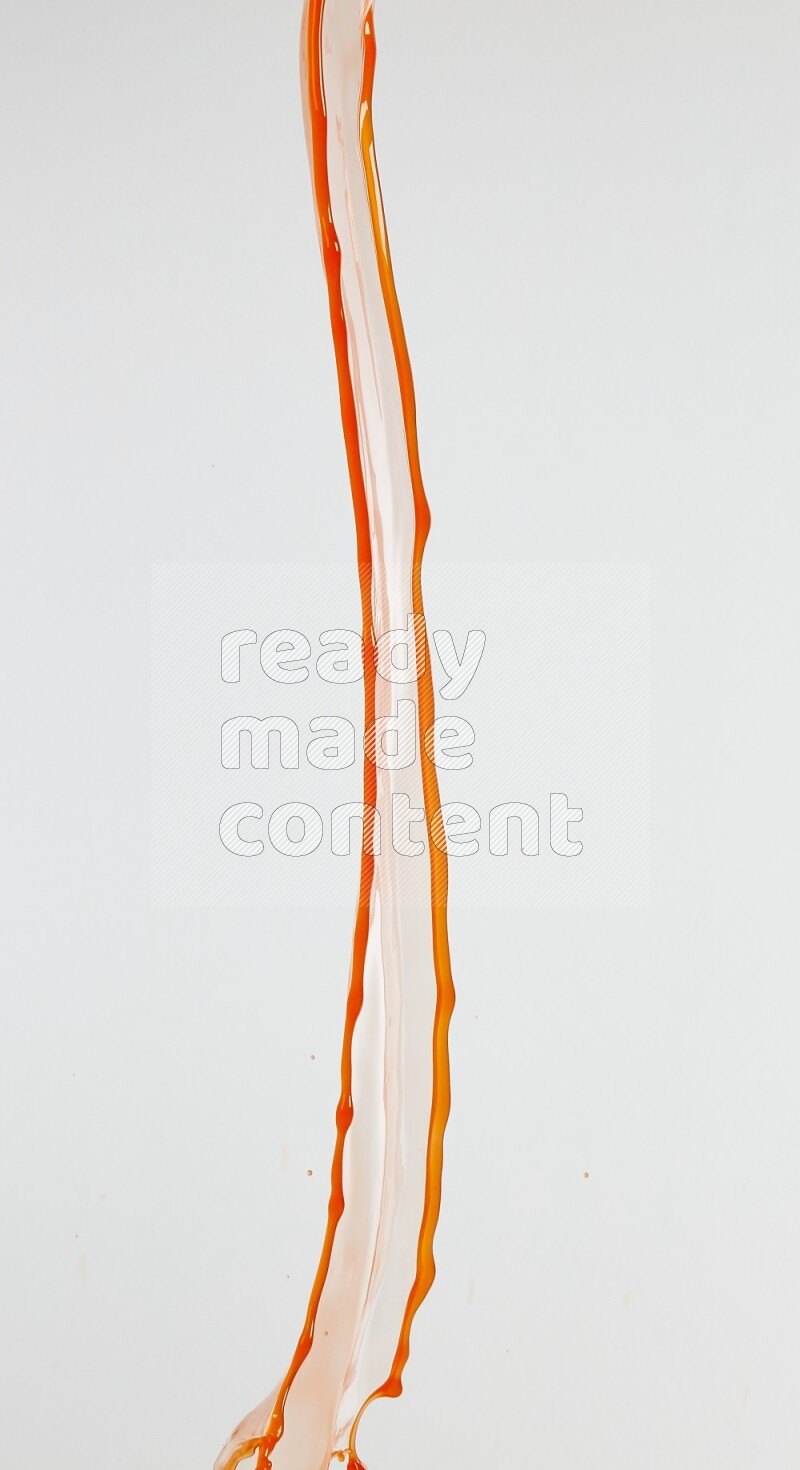 Orange liquid splash and drops on white background