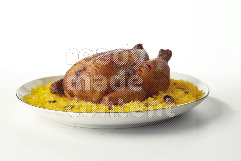 yellow  basmati Rice with kabsa chicken pieces on a white plate with a silver rim direct on white background