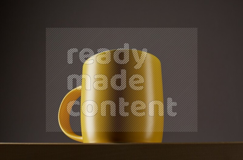 Low angle shot of a yellow cup on grey background