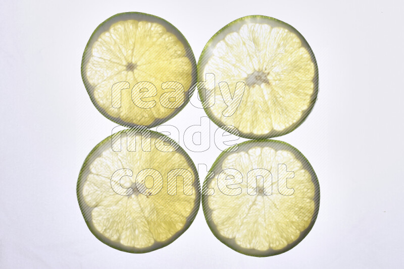 Orange slices on illuminated white background