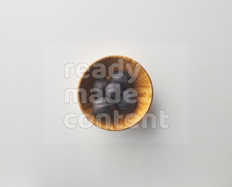 Top-view shot of dried lime (loomi) in a container on white background