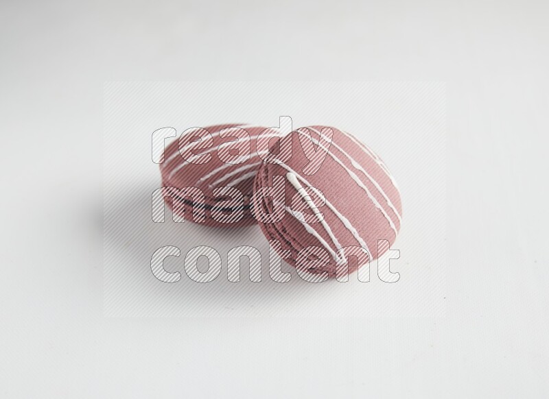 45º Shot of two Red Poppy Flower macarons on white background