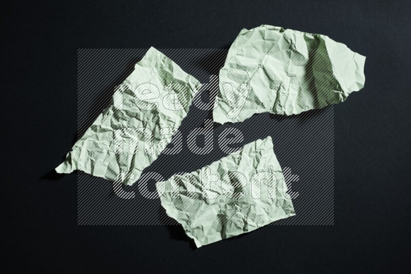 Green paper sheet on black background