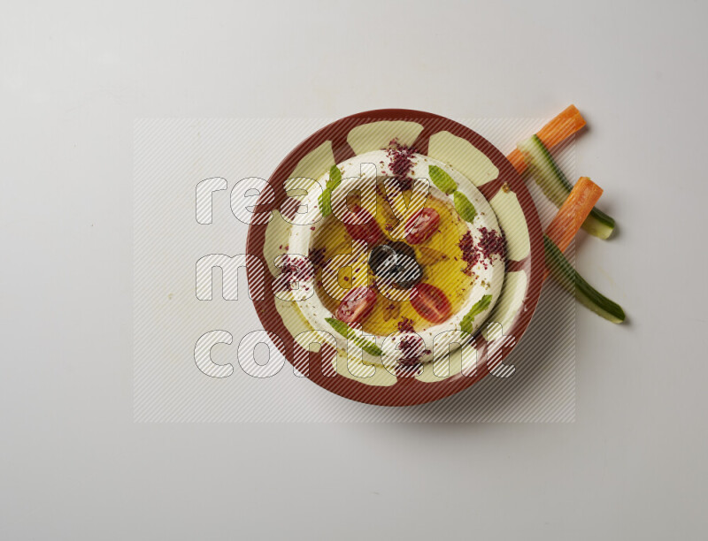 Lebnah garnished with Cherry tomato, mint & sumak  in a traditional plate on a white background