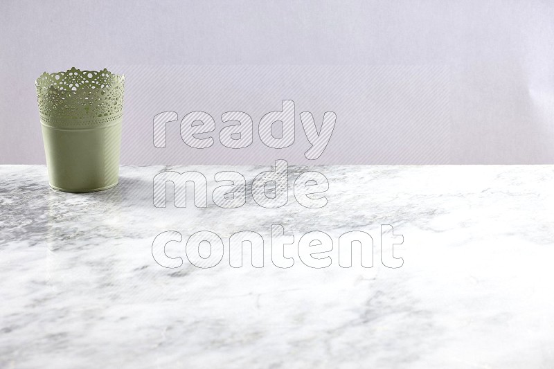 An Empty Light Green Plant Pot on light grey Marble Flooring 45 degree angle