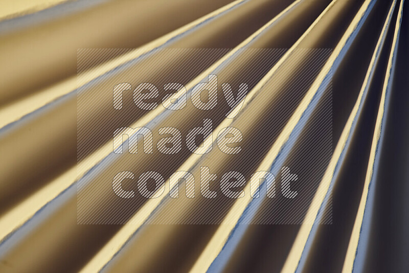 An image presenting an abstract paper pattern of lines in blue and gold tones