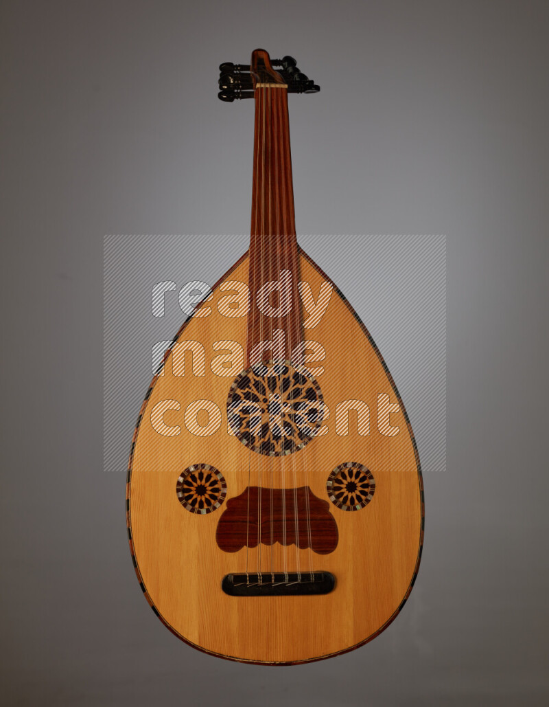 a wooden brown Oud on a gray background