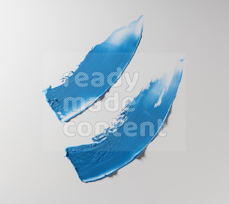 Blue curved painting knife strokes on white background