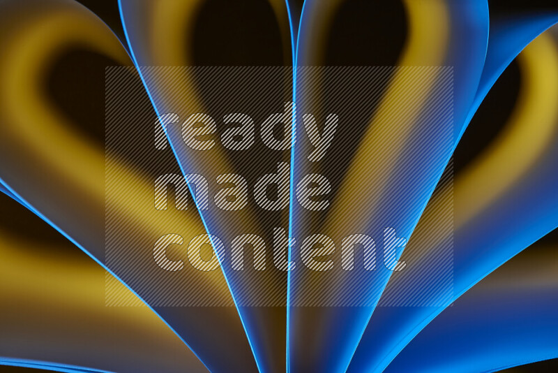 An abstract art piece displaying smooth curves in yellow and blue gradients created by colored light