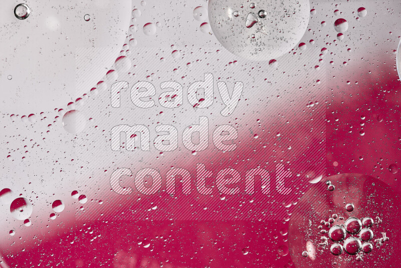 Close-ups of abstract oil bubbles on water surface in shades of white and pink