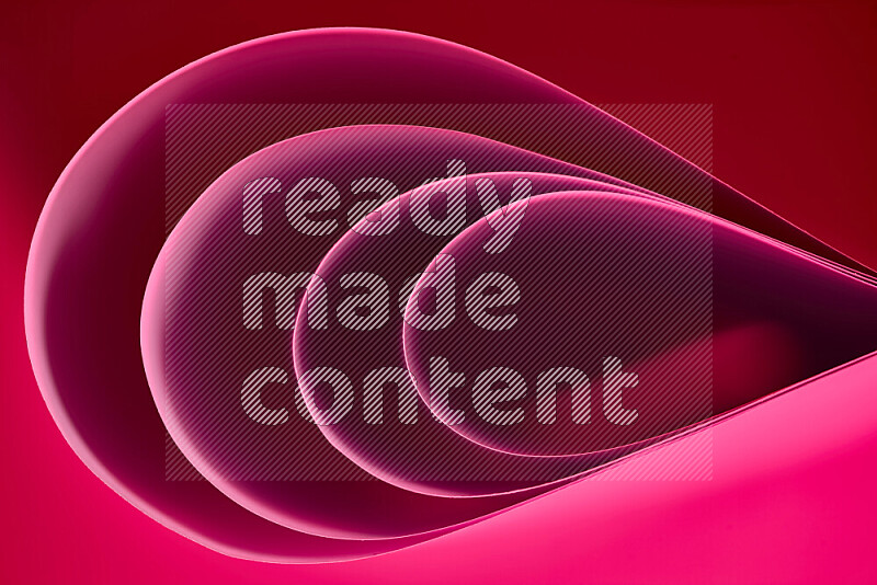 An abstract art of paper folded into smooth curves in pink gradients